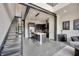 Contemporary open-concept kitchen with a sleek island and modern steel staircase at 4047 Gauge Line Loop, Tampa, FL 33624