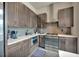 Well-lit kitchen with stainless appliances, stylish backsplash, and sleek countertops at 4047 Gauge Line Loop, Tampa, FL 33624