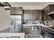 Modern kitchen with stainless steel appliances, stylish backsplash, and ample counter space at 4047 Gauge Line Loop, Tampa, FL 33624