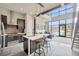 Open layout kitchen with island seating, modern lighting, and pond view at 4047 Gauge Line Loop, Tampa, FL 33624