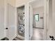 Convenient laundry closet with stacked washer and dryer, leading to a bedroom at 4047 Gauge Line Loop, Tampa, FL 33624