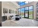 Bright living room with floor-to-ceiling windows and view of the pond at 4047 Gauge Line Loop, Tampa, FL 33624