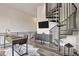 Stylish living room with spiral staircase, contemporary desk, and sophisticated decor at 4047 Gauge Line Loop, Tampa, FL 33624