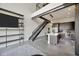 Open living area with a modern kitchen, industrial staircase, and stylish shelving at 4047 Gauge Line Loop, Tampa, FL 33624