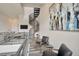 Open living area with modern decor, spiral staircase, and large abstract art piece at 4047 Gauge Line Loop, Tampa, FL 33624