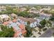 Aerial view of a multi-story white home with a brown roof nestled among lush greenery and other colorful homes at 412 S Albany Ave # 2, Tampa, FL 33606