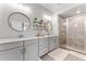 Modern bathroom with double vanity, granite counters, and a glass-enclosed shower at 412 S Albany Ave # 2, Tampa, FL 33606