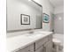 Modern bathroom featuring a quartz countertop, undermount sink, framed mirror, and tiled shower at 412 S Albany Ave # 2, Tampa, FL 33606