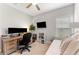 Bedroom space with hardwood floors, ceiling fan, futon, and two monitors on the light wood desk at 412 S Albany Ave # 2, Tampa, FL 33606