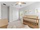 Bedroom with crib, neutral walls, and light-colored carpet at 412 S Albany Ave # 2, Tampa, FL 33606