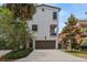 Charming stucco home featuring a two-car garage, balcony, and well-manicured landscaping at 412 S Albany Ave # 2, Tampa, FL 33606