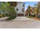 Charming stucco home featuring a two-car garage, balcony, and mature tree landscaping at 412 S Albany Ave # 2, Tampa, FL 33606