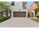 Attractive two-car garage with a concrete driveway and beautiful exterior of a stucco home at 412 S Albany Ave # 2, Tampa, FL 33606