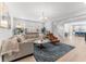 Bright living room with light hardwood floors, neutral furniture, and a contemporary chandelier at 412 S Albany Ave # 2, Tampa, FL 33606