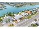 Aerial view of waterfront homes with private docks on a canal leading to the ocean at 440 115Th Ave, Treasure Island, FL 33706