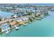 Waterfront homes with private docks along a canal leading to the ocean, as seen from an aerial view at 440 115Th Ave, Treasure Island, FL 33706