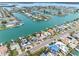 Expansive aerial view of a waterfront property with lush landscaping, private dock, and tranquil community setting at 440 115Th Ave, Treasure Island, FL 33706