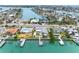 An aerial shot shows waterfront homes with private docks, in a neighborhood on a canal leading to the ocean at 440 115Th Ave, Treasure Island, FL 33706