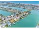 An aerial view showcases waterfront homes with private docks on a canal leading to the ocean at 440 115Th Ave, Treasure Island, FL 33706