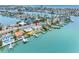Waterfront homes with private docks along a canal leading to the ocean, as seen from an aerial view at 440 115Th Ave, Treasure Island, FL 33706