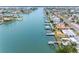 Aerial view shows a canal lined with waterfront homes and docks leading out to the ocean at 440 115Th Ave, Treasure Island, FL 33706
