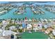 Breathtaking aerial view of a coastal neighborhood, showcasing waterfront homes, private docks, and boat-friendly canals at 440 115Th Ave, Treasure Island, FL 33706