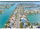 Stunning aerial shot of the property with waterfront access, boat docks, lush greenery, and charming neighborhood at 440 115Th Ave, Treasure Island, FL 33706
