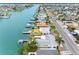 An aerial view shows waterfront homes with docks lining a canal on a sunny day at 440 115Th Ave, Treasure Island, FL 33706