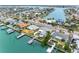 An aerial shot shows waterfront homes with private docks, in a neighborhood on a canal leading to the ocean at 440 115Th Ave, Treasure Island, FL 33706