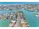 Aerial view of waterfront homes with private docks along a canal leading to the ocean at 440 115Th Ave, Treasure Island, FL 33706