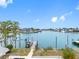 Scenic canal view with a private dock and boat lift, perfect for enjoying waterfront activities with mature tropical foliage at 440 115Th Ave, Treasure Island, FL 33706
