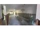Spacious living room ready for remodel, featuring classic chandelier and abundant natural light at 4560 Overlook Ne Dr # 167, St Petersburg, FL 33703