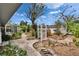 Landscaped backyard with arbor, walkways, and enclosed patio at 508 E Brentridge, Brandon, FL 33511