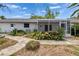 Landscaped backyard featuring a screened in porch and walkway at 508 E Brentridge, Brandon, FL 33511