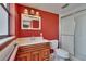 Bathroom featuring bright red walls, and a single sink vanity with a shower and toilet at 508 E Brentridge, Brandon, FL 33511