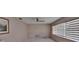 This bedroom features tiled floors, a ceiling fan, and horizontal blinds on the windows for filtered natural light at 508 E Brentridge, Brandon, FL 33511