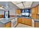 Functional kitchen featuring wood cabinets, a smooth top range, and tile flooring for easy maintenance at 508 E Brentridge, Brandon, FL 33511