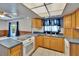 This kitchen features a stove top, wood cabinetry, stainless steel sink, and an eat-in bar top counter at 508 E Brentridge, Brandon, FL 33511