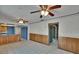 Spacious living room features two ceiling fans, wood paneling detail, and an open floor plan to the kitchen at 508 E Brentridge, Brandon, FL 33511