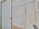 Shower with white tile, a sliding glass door, mounted shower head and accessibility bar at 508 E Brentridge, Brandon, FL 33511