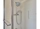 Shower with white tile, a sliding door, mounted shower head and accessibility bar at 508 E Brentridge, Brandon, FL 33511