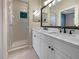 Bathroom featuring a glass-enclosed shower and a double vanity with modern fixtures at 5636 Whitehead St, Bradenton, FL 34203