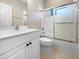 Bright bathroom featuring a shower and bathtub combo with a glass door, and a white vanity at 5636 Whitehead St, Bradenton, FL 34203