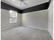 Neutral bedroom featuring gray walls and carpet, a window, and a closet, ready for personalization at 5636 Whitehead St, Bradenton, FL 34203