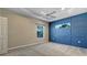 Spacious bedroom with custom blue accent wall, carpet, and a large window for natural light at 5636 Whitehead St, Bradenton, FL 34203