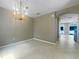 Bright dining room with tile floors and a modern chandelier, adjacent to the entrance at 5636 Whitehead St, Bradenton, FL 34203