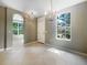 Welcoming entrance area with an elegant chandelier and large window showcasing the landscaping at 5636 Whitehead St, Bradenton, FL 34203