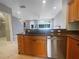 Well-appointed kitchen with granite countertops, stainless steel appliances, and a breakfast bar overlooking the living area at 5636 Whitehead St, Bradenton, FL 34203