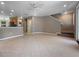 Open-concept living area with tile flooring and staircase, seamlessly connecting living, dining, and kitchen spaces at 5636 Whitehead St, Bradenton, FL 34203