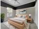 Bright main bedroom with a ceiling fan, neutral walls, and a large window letting in natural light at 5636 Whitehead St, Bradenton, FL 34203